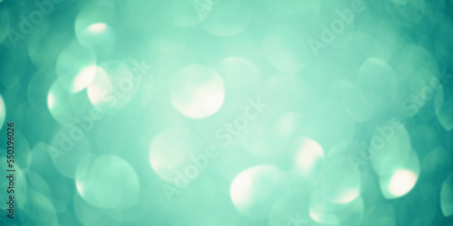 Green glitter background defocus light. Round defocuses on a blurred background.