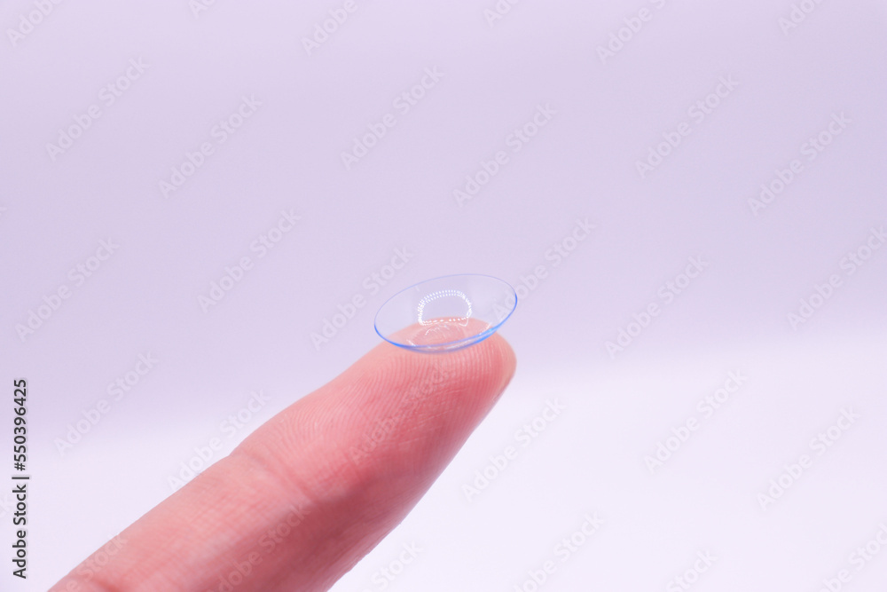 Two contact lanses on finger on white background Two contact lanses on finger on white background