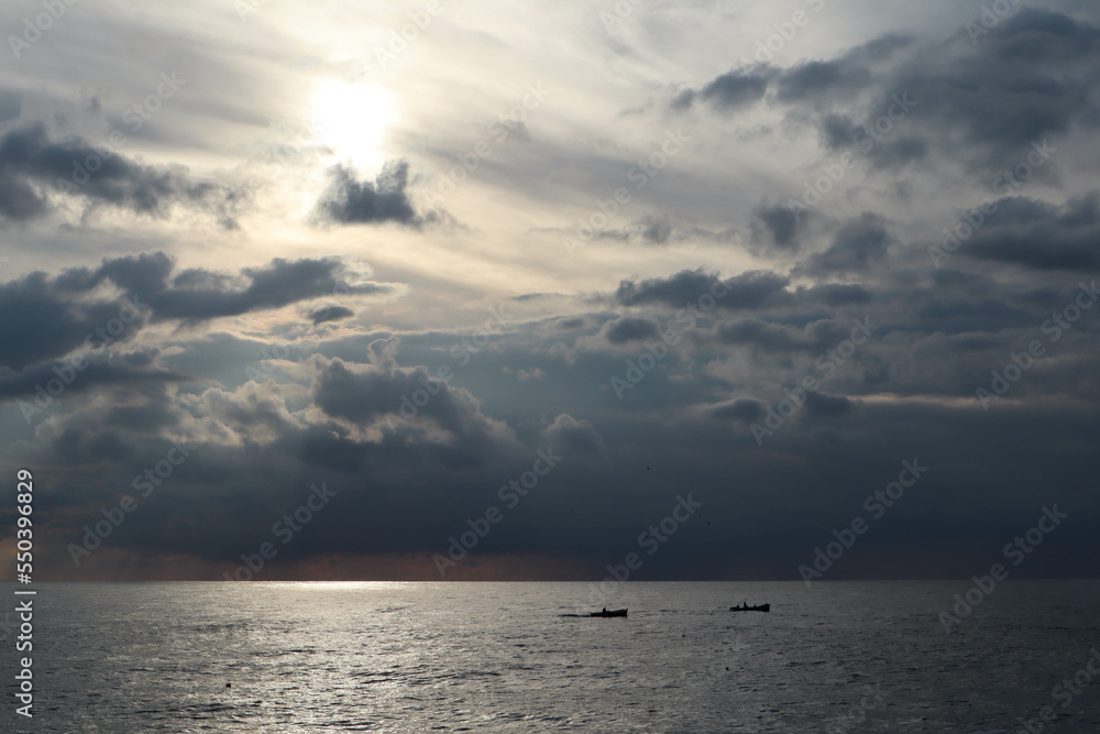 sunset over the sea with the sun and clouds