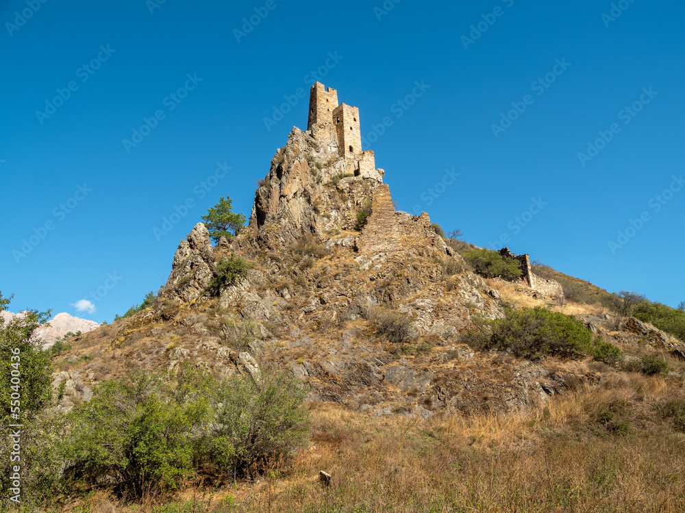 Hard-to-reach ancient battle towers on the rocks. Unique medieval tower complex Vovnushki, one of the authentic medieval castle-type tower villages, located in Ingushetia.