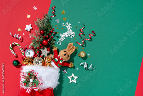 Holiday explosion from Christmas sock on green background. Merry Christmas and Happy New Year concept