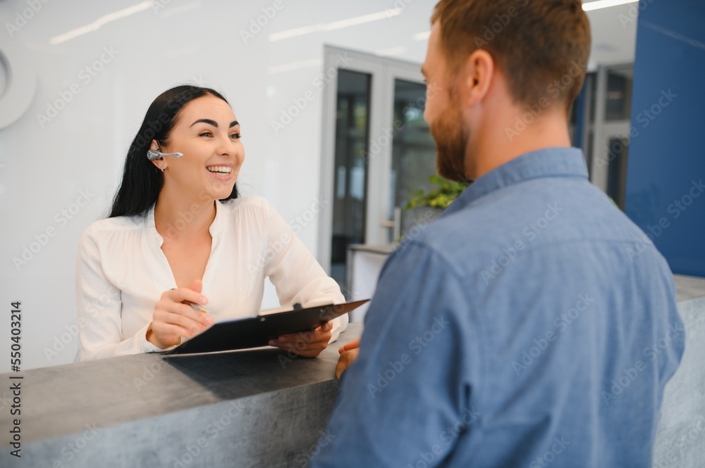 Excellent service. Nice friendly woman talking to the client while standing at the reception. Excellent service. Nice friendly woman talking to the client while standing at the reception.