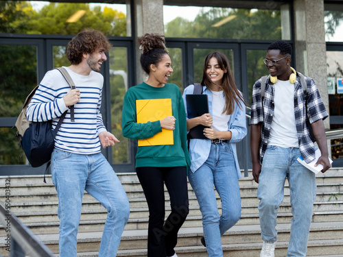 Group of diverse college students talking to each other and walking on campus