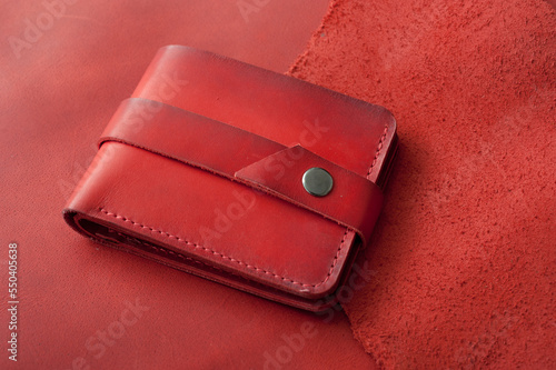 Red genuine leather wallet on the table, accessories for men, handmade products of small business