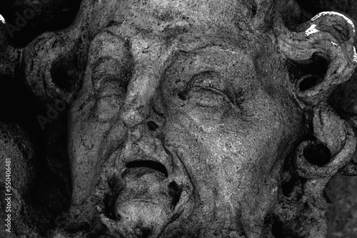 Foto Fragment of an ancient statue of Sisyphus with stone