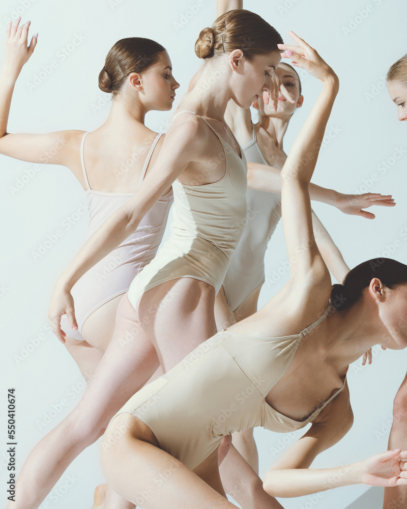 Group of young women, ballerinas dancing, performing isolated over grey studio background. Expression of grace - obrazy, fototapety, plakaty 