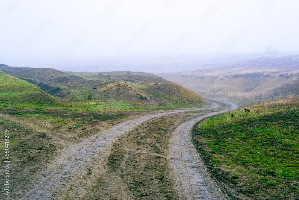 dirt muddy road wet Puddle countryside autumn fall green grass   steppe after rain Tire tracks beautiful landscape  Moldova Causeni Extreme path rural  Broken impassable pasture