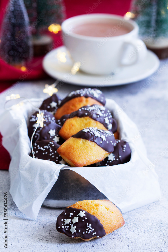 Traditional French madeleine cookies served with coffee, Christmas decor.