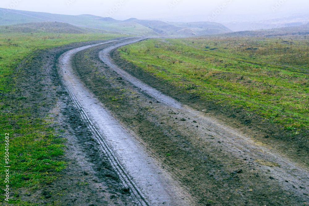 dirt muddy road wet Puddle countryside autumn fall green grass   steppe after rain Tire tracks beautiful landscape  Moldova Causeni Extreme path rural  Broken impassable pasture