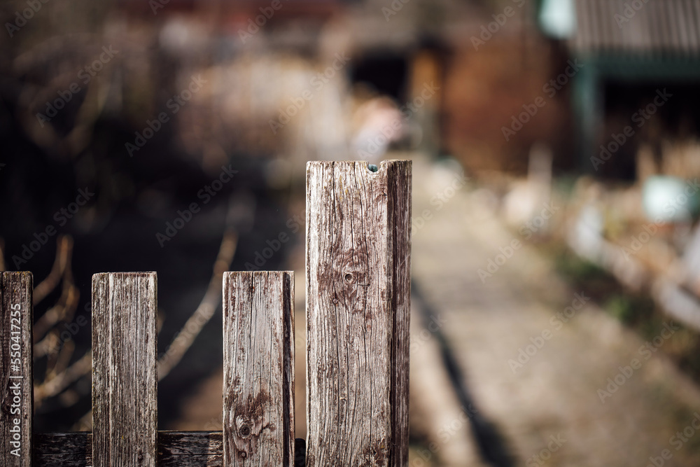 Wooden old brown fence with blurred background, outdoor, garden