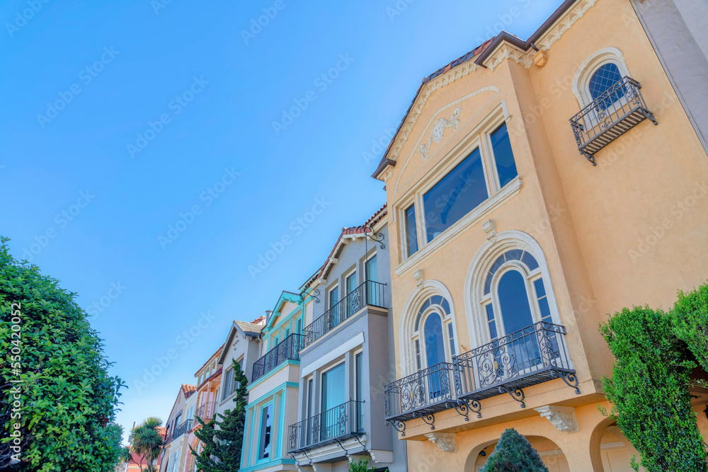 Three-storey homes with reflective windows and window railings at San Francisco, California Three-storey homes with reflective windows and window railings at San Francisco, California