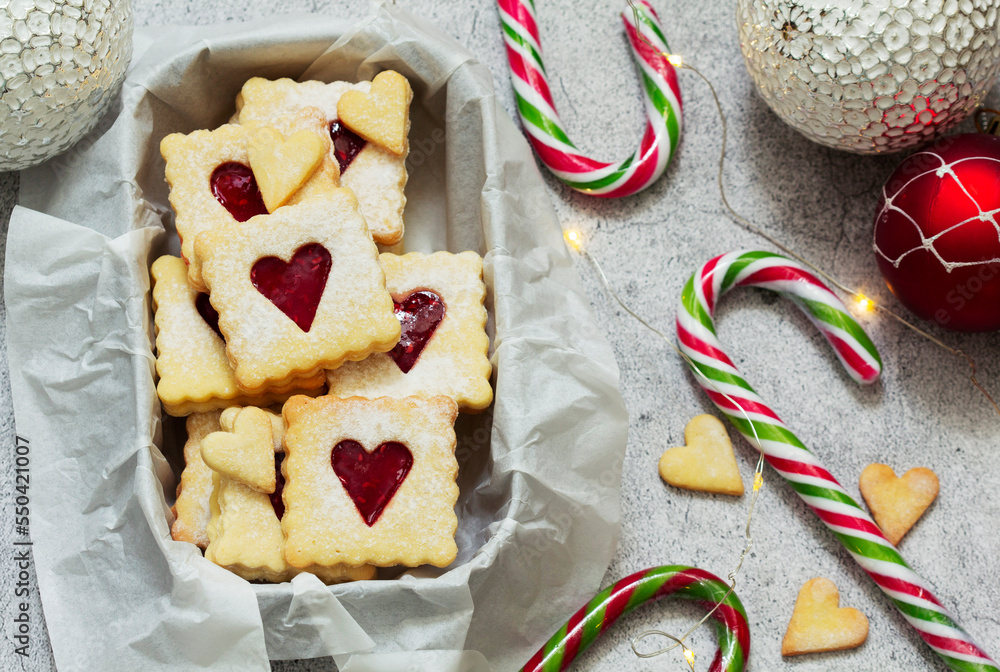 Sugar cookies stuffed with raspberry jam on a light background. Christmas and New Year's decor.