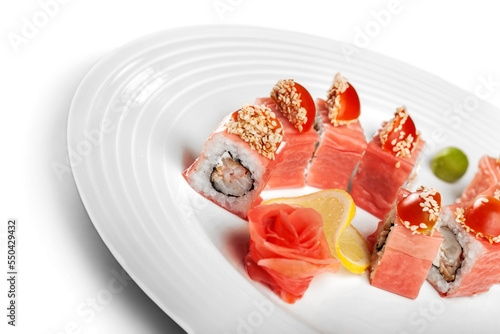 Tasty Sushi rolls on plate on  background