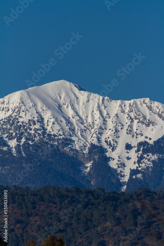 snowy mountain photo with blue sky background © Arda