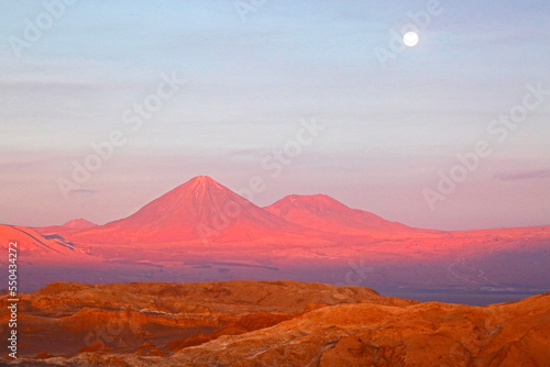 The full moon rising above the famous Valley of the Moon / Valle de la Luna near San Pedro de Atacama, Chile. photo