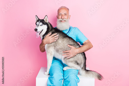 Photo of male vet examine purebred husky vaccine rabies isolated on pastel color background