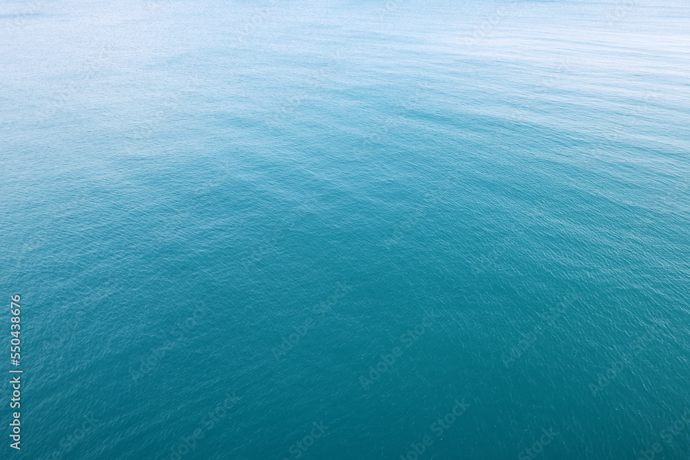 Aerial view of a clear sea water texture. Natural blue background. Blue water reflection. Mediterranean sea. Aerial view of a clear sea water texture. Natural blue background. Blue water reflection. Mediterranean sea.