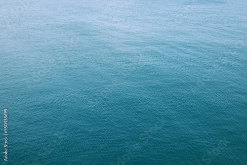 Aerial view of sea surface water texture background and sun reflections Aerial flying drone view Waves water surface texture on sunny tropical ocean Top view nature background