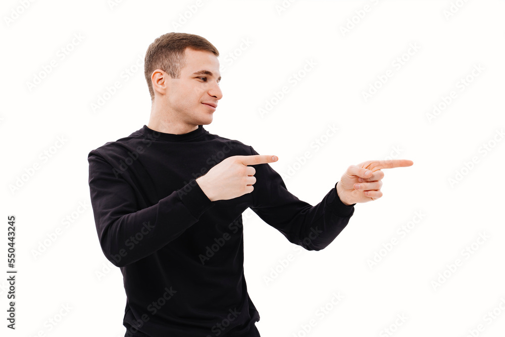 a man in black clothes points his finger at something on a white background. a man in black clothes points his finger at something on a white background.