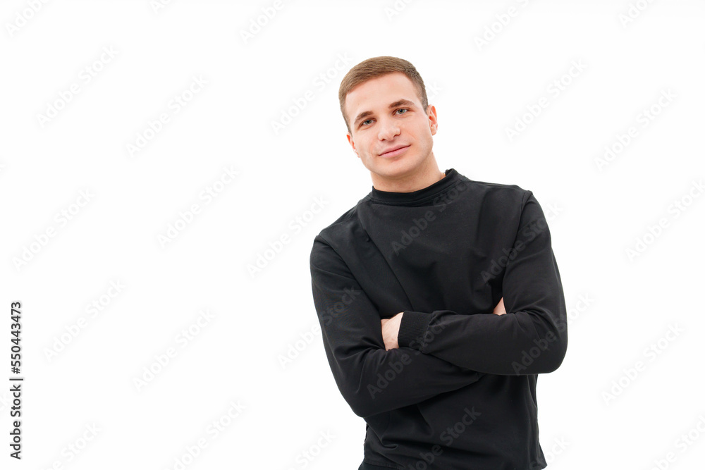 a man in black clothes with his arms crossed on his chest on a white background. a man in black clothes with his arms crossed on his chest on a white background.