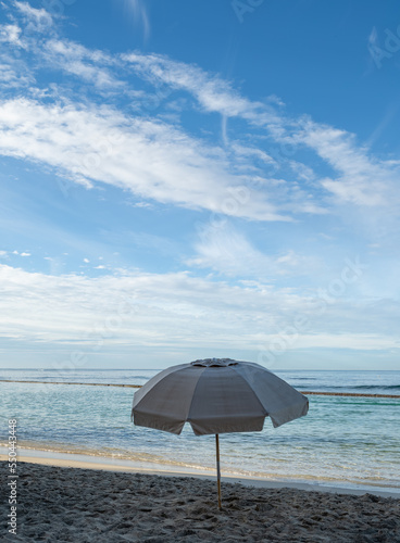 Seascape in Waikiki Hawaii of a Deserted Beach with an Umbrella.