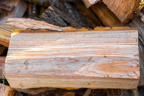 Wooden log split in half. Background for text. Preparation of firewood for heating in winter