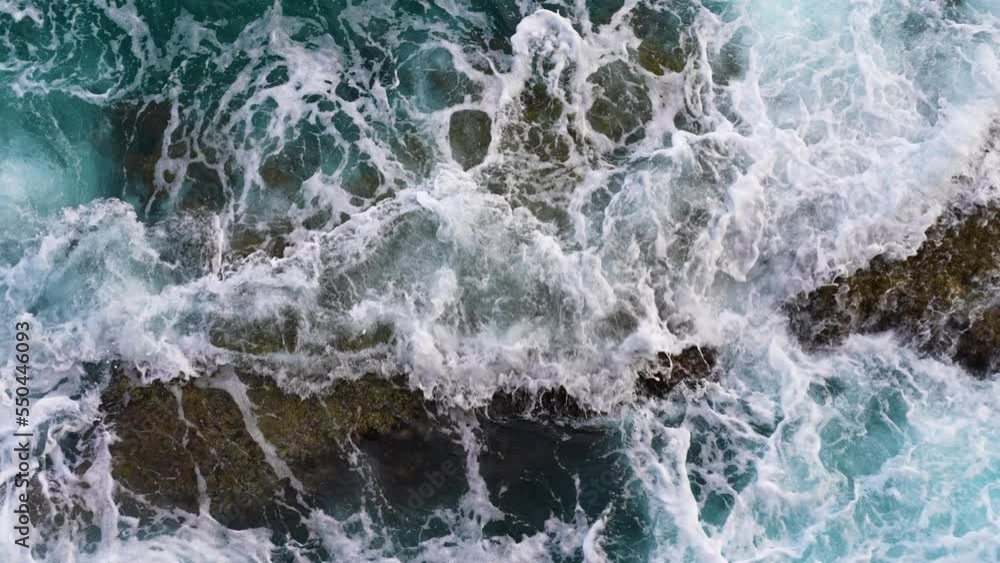 Storm waves, foam and rocks of the sea water of the Mediterranean. Azure water. Antalya. Sea foam, ocean foam, beach foam, or spume is a type of foam created by the agitation of seawater Storm waves, foam and rocks of the sea water of the Mediterranean. Azure water. Antalya. Sea foam, ocean foam, beach foam, or spume is a type of foam created by the agitation of seawater