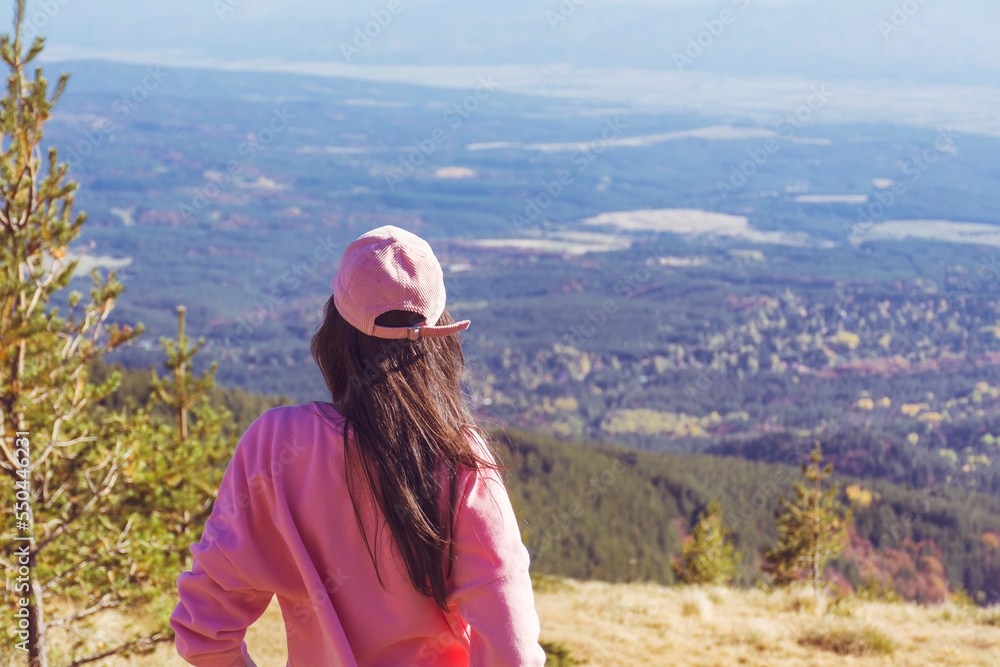 Woman with pink hat standing high in the autumn  mountain . Vitosha mountain ,Bulgaria