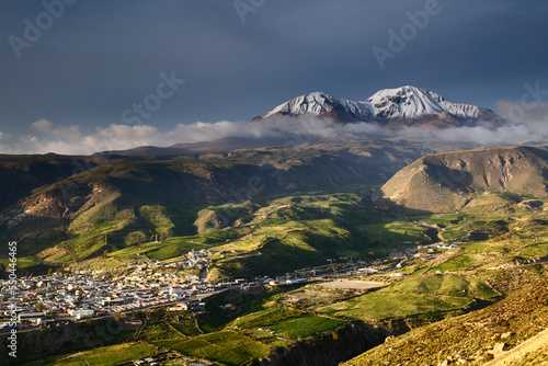 A view over the small town of Putre, with the Taapaca / Nevados de Putre volcano complex (5860m / 19,925ft) in the background, Region XV, Chile. photo