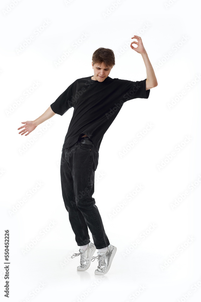 young man in black t-shirt and jeans dancing