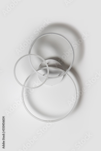 Chandelier in the form of three rings against a white ceiling
