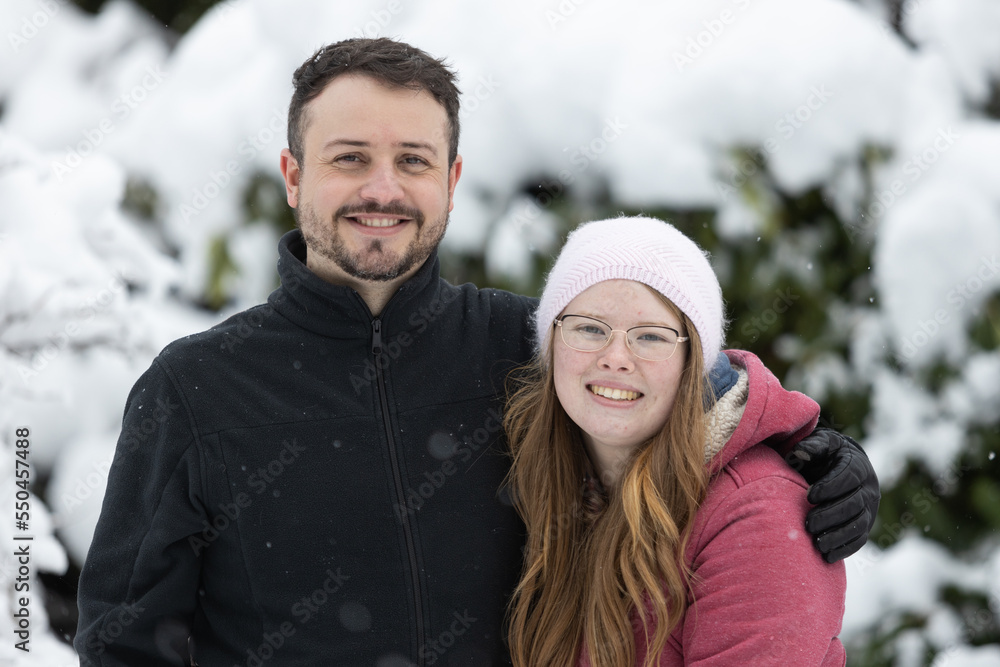 Young couple outside on a snowy day in winter Young couple outside on a snowy day in winter