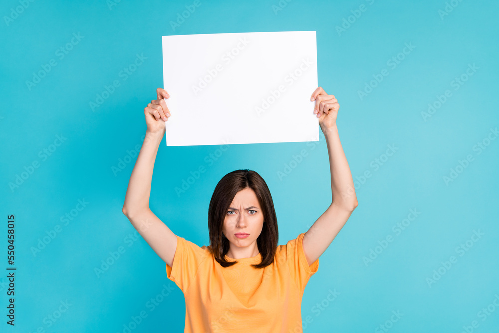 Photo of unsatisfied lady raise hand white paper sheet dislike new low act choice empty space isolated on blue color background Photo of unsatisfied lady raise hand white paper sheet dislike new low act choice empty space isolated on blue color background