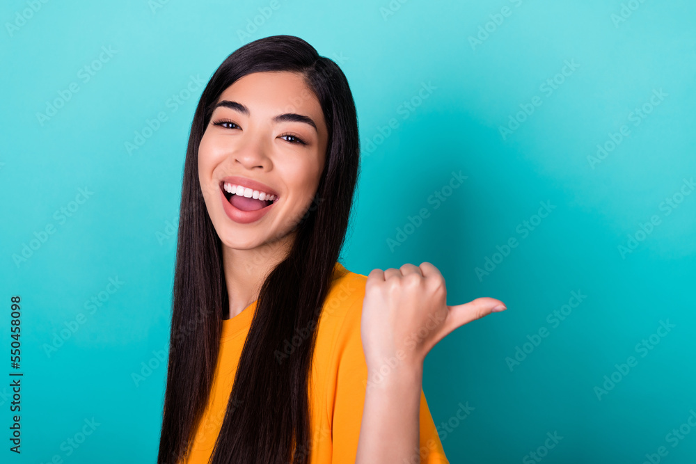 Photo of gorgeous pretty lovely girl with long hairstyle dressed yellow clothes indicating empty space isolated on teal color background Photo of gorgeous pretty lovely girl with long hairstyle dressed yellow clothes indicating empty space isolated on teal color background