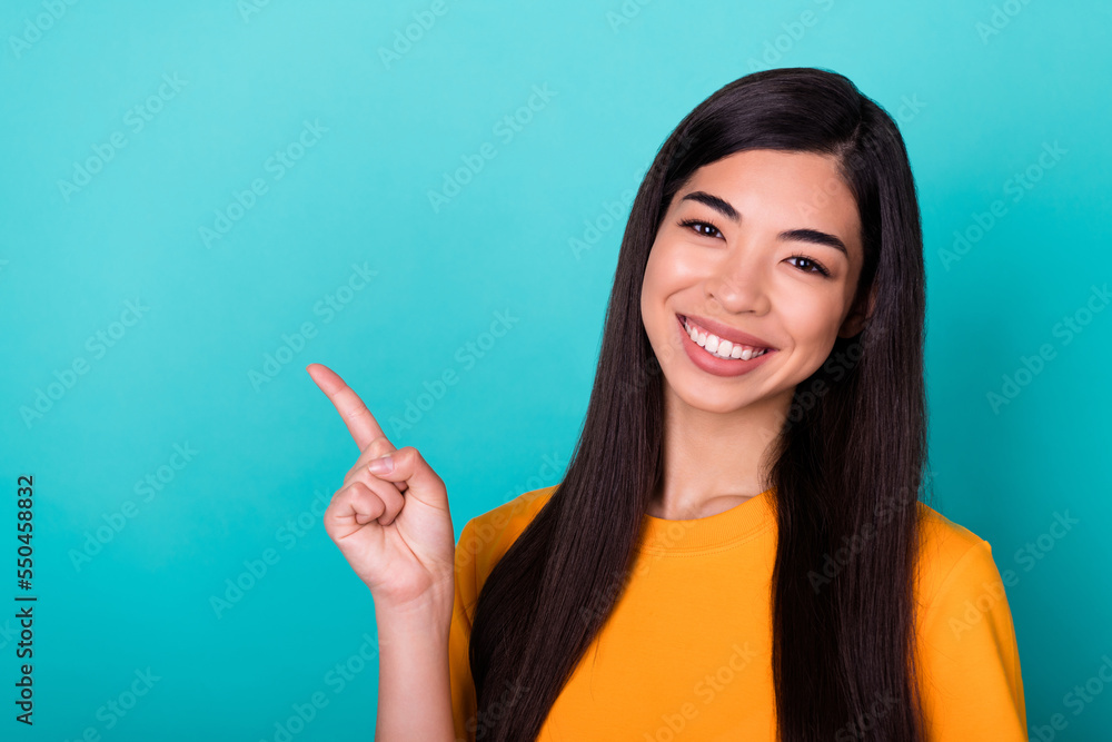 Photo of nice pretty cute woman with straight hairstyle wear yellow t-shirt indicating empty space isolated on turquoise color background Photo of nice pretty cute woman with straight hairstyle wear yellow t-shirt indicating empty space isolated on turquoise color background