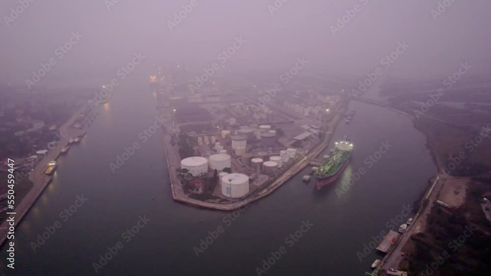 Aerial view of an industrial seaport in northern Italy. Constructions, technologies and infrastructure of a port. Ships and ferryboat. Aerial view of an industrial seaport in northern Italy. Constructions, technologies and infrastructure of a port. Ships and ferryboat.