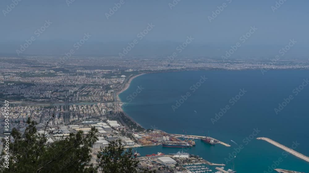 Aerial view time-lapse of Antalya city. Urban skyline. Landscape. Panorama of the Antalya city from the top of the mountain. The clouds shadows falls to the city. Aerial view time-lapse of Antalya city. Urban skyline. Landscape. Panorama of the Antalya city from the top of the mountain. The clouds shadows falls to the city.