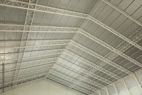 Steel roof structure. Detail of steel roof structure warehouse or gymnasium with transparent tile strips and roof ventilation system in bottom view with copy space and focus.