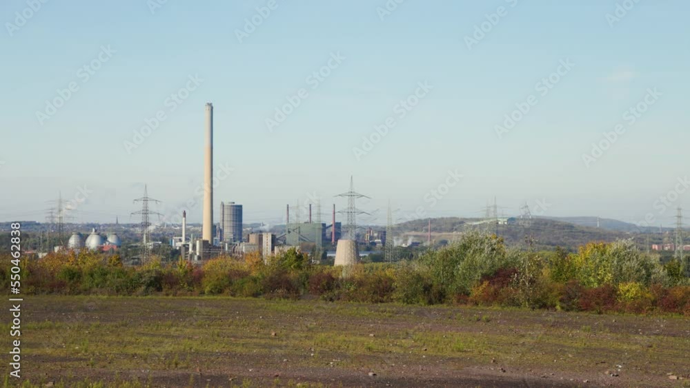 The Essen-Karnap waste-to-energy plant (waste incineration) in Essen, North Rhine - Westphalia, Germany. Industrial landscape with chimneys, smoke, steam, high voltage pylons and buildings. The Essen-Karnap waste-to-energy plant (waste incineration) in Essen, North Rhine - Westphalia, Germany. Industrial landscape with chimneys, smoke, steam, high voltage pylons and buildings.