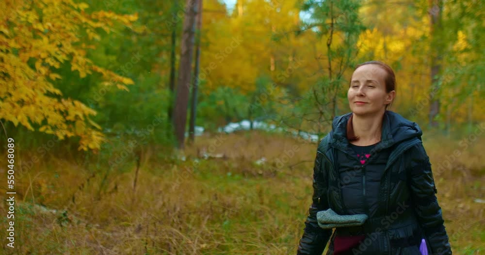 Happy woman walks through the autumn forest.Woman admires nature and smiles. Beautiful autumn landscape, golden foliage. Romantic walk in the forest. 4k, ProRes Happy woman walks through the autumn forest.Woman admires nature and smiles. Beautiful autumn landscape, golden foliage. Romantic walk in the forest. 4k, ProRes