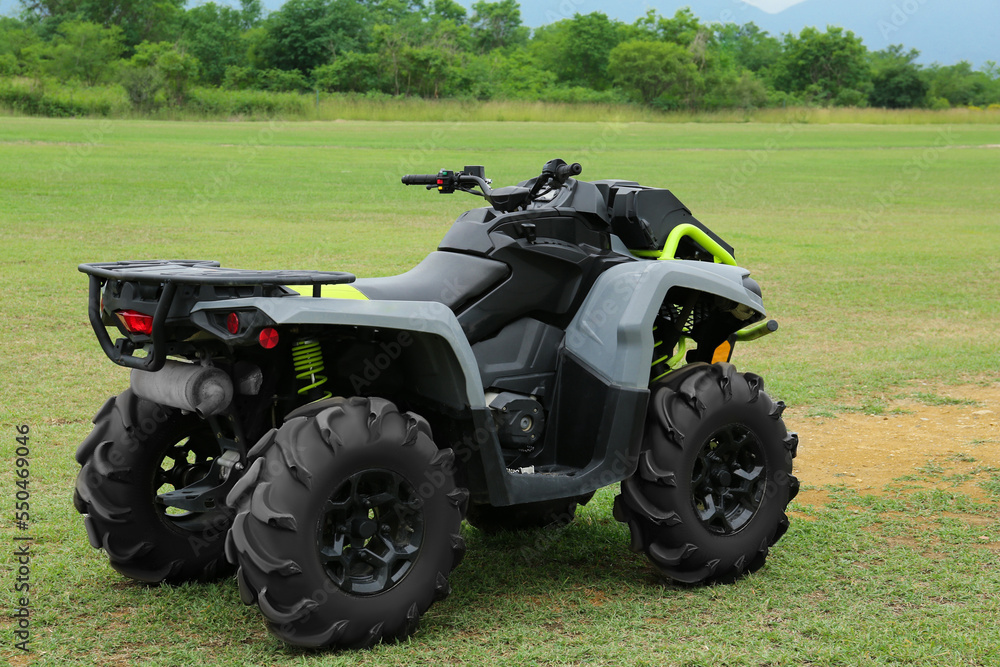 Obraz premium Modern quad bike on green grass outdoors