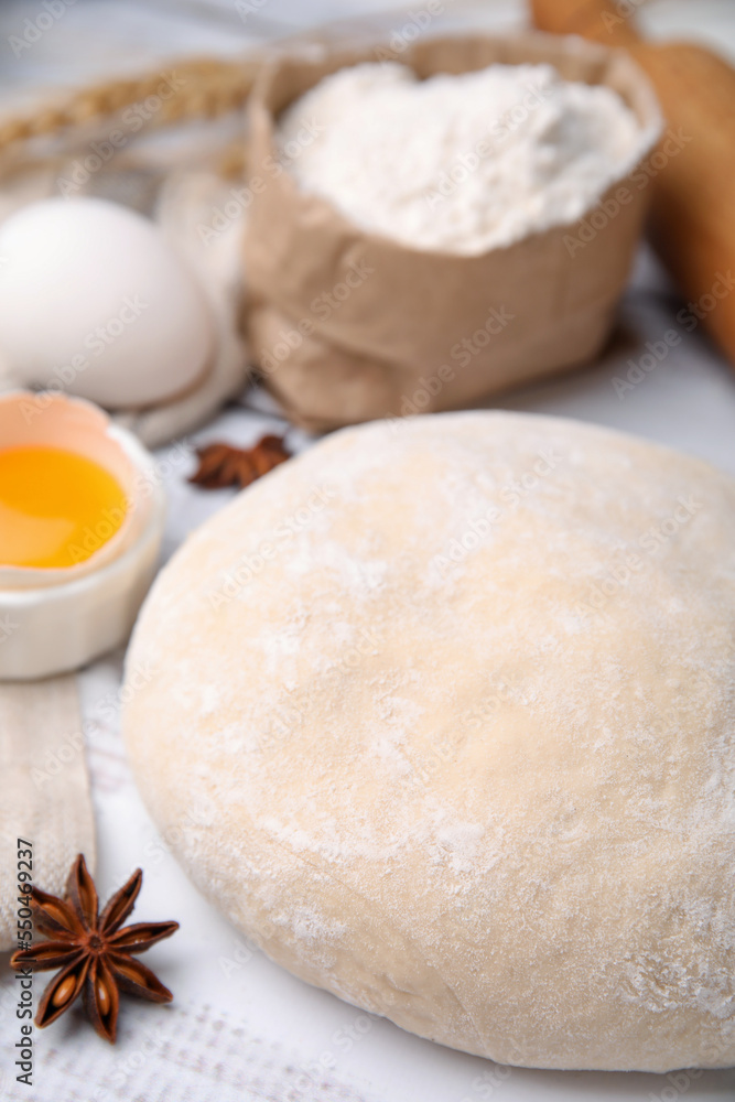 Fresh dough and ingredients on white wooden table, closeup Fresh dough and ingredients on white wooden table, closeup