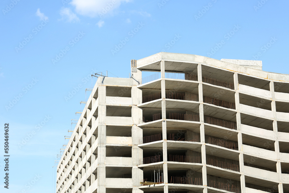Construction site with unfinished building on sunny day Construction site with unfinished building on sunny day