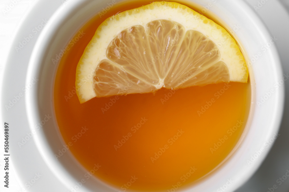 Cup with delicious immunity boosting tea and lemon, closeup Cup with delicious immunity boosting tea and lemon, closeup