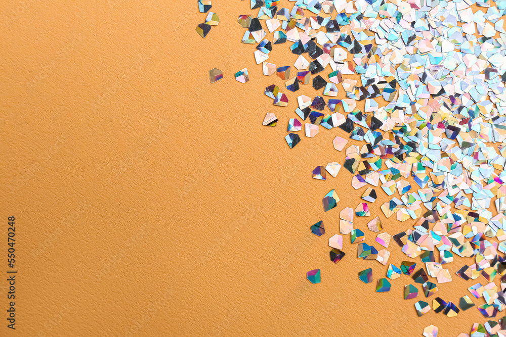 Shiny bright glitter on beige background. Space for text Shiny bright glitter on beige background. Space for text