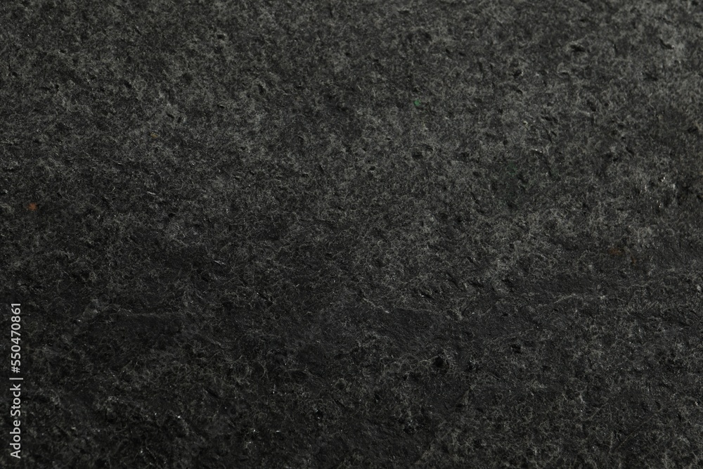 Fototapeta premium Texture of dark grey stone surface as background, closeup