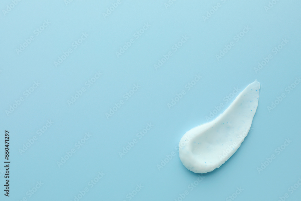 Sample of face scrub on light blue background, top view. Space for text Sample of face scrub on light blue background, top view. Space for text