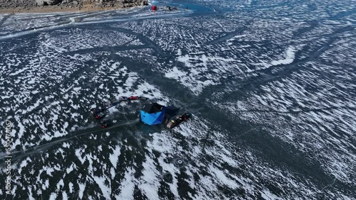 Aerial mountain lake ice fishing Utah circle 6. Outdoor winter recreation and sport. Mountain alpine lake. Social activity with family and friends. Ice forms for safety. Tents and heaters for comfort. photo