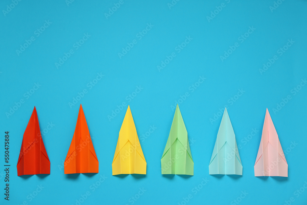 Flat lay composition with different paper planes on light blue background, space for text Flat lay composition with different paper planes on light blue background, space for text