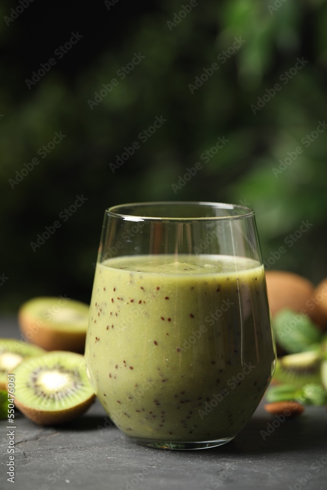 Delicious kiwi smoothie and fresh fruits on grey table Delicious kiwi smoothie and fresh fruits on grey table